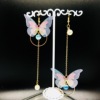 Long fashionable asymmetrical earrings from pearl with tassels