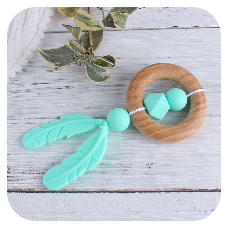 Nueva historieta DIY Beech anillo de mano molar de juguete mordedor infantil pluma de silicona perlas dientes de molienda palo