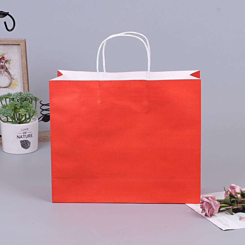 厂家直供牛皮纸袋白卡纸手提袋 商场服用包装袋 购物袋可批发