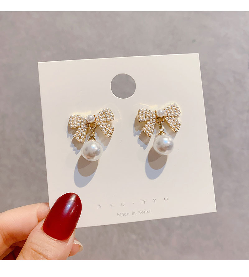Korean Fashion Bow Inlaid Pearl Copper Drop Earrings Female display picture 4