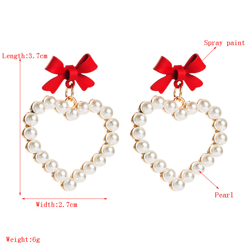 Alloy Spray Paint Bow Love Heart-shaped Imitation Pearl Earrings display picture 1