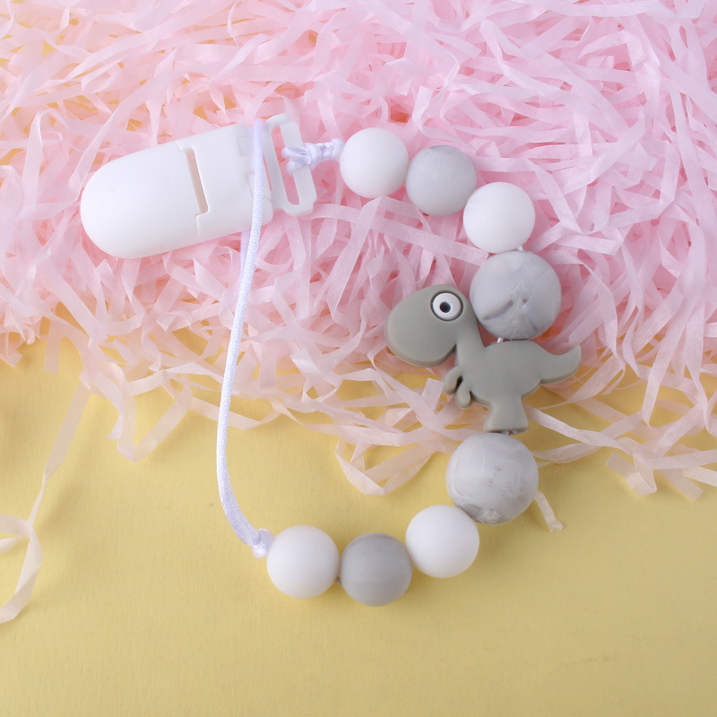 Pequeño dinosaurio bebé silicona pezón clip Cadena de dientes de bebé Cadena de molienda cadena anti-gota calmante teether pezón