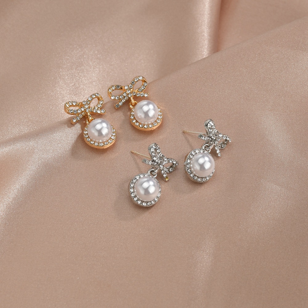 S925 Silver Needle Korea Sweet And Cute Fairy Fashion Bow Pearl Alloy Earrings Wholesale display picture 1