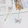 Long fashionable asymmetrical earrings from pearl with tassels