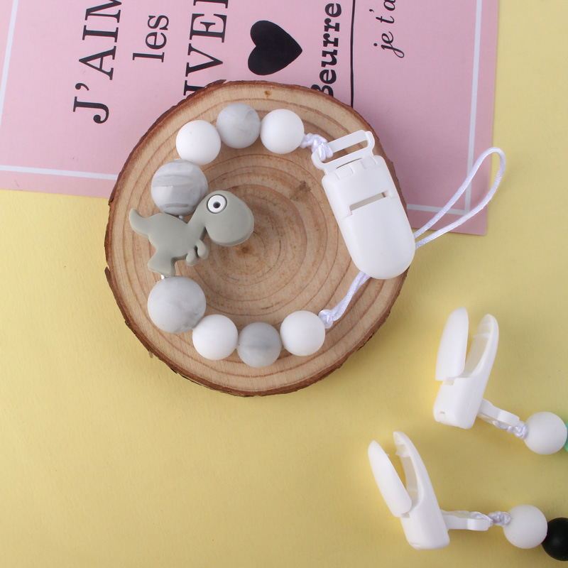 Pequeño dinosaurio bebé silicona pezón clip Cadena de dientes de bebé Cadena de molienda cadena anti-gota calmante teether pezón
