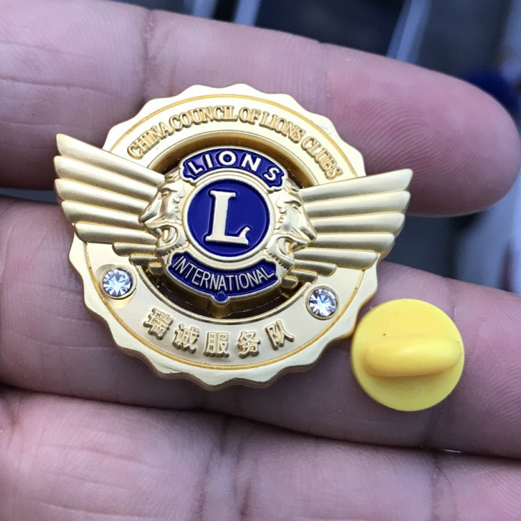 Golden three dimensional design badge
