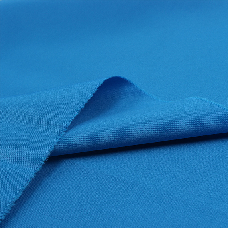 现货宝蓝全涤平纹桃皮绒布料涤纶布磨毛桃皮绒服帽箱包沙滩裤面料