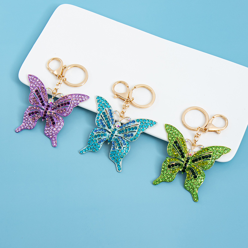 Estilo coreano moda color diamante serie completa aleación hueco mariposa llavero colgante bolsa de accesorios regalo al por mayor