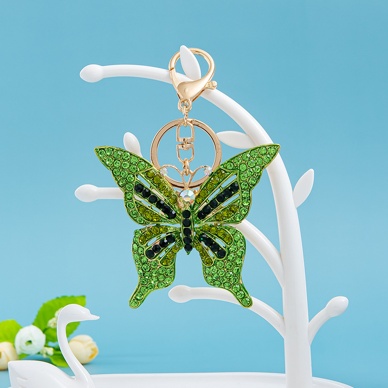 Estilo coreano moda color diamante serie completa aleación hueco mariposa llavero colgante bolsa de accesorios regalo al por mayor