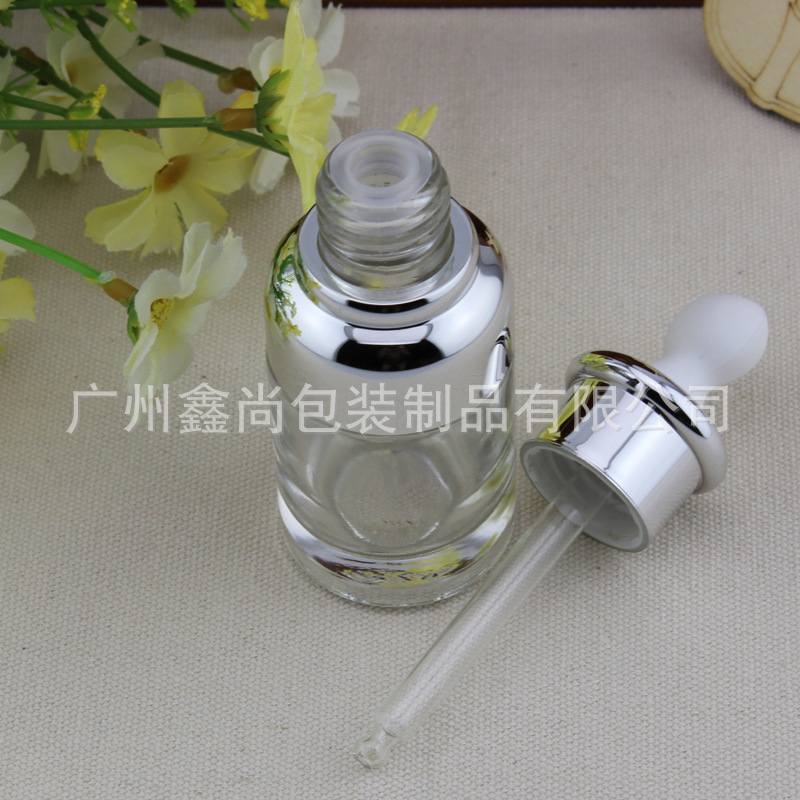 Botella de vidrio transparente de alta gama 20ml botella de esencia cabeza de goma plana botella de aceite esencial botella cuentagotas botella de líquido cosmético vacío