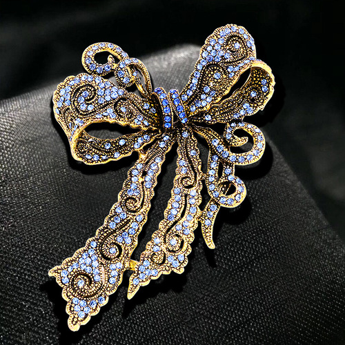 Cross-border hot selling creative rhinestone brooch alloy electroplated retro bow women's corsage high-end accessories pin