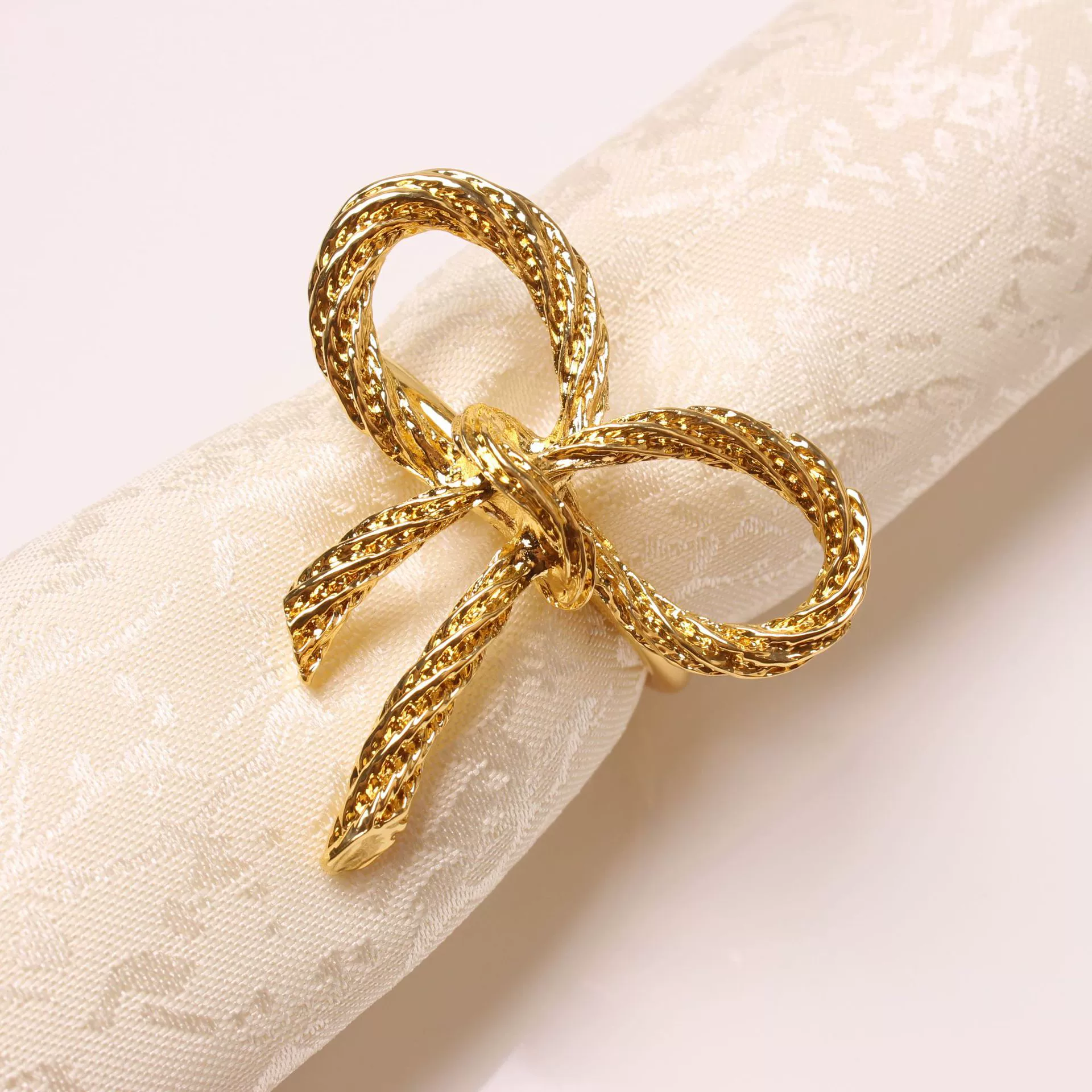 Golden paper napkins with bow, bow tie, fashionable accessory, simple and elegant design