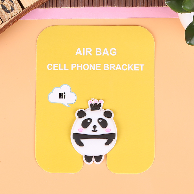 En stock al por mayor TikTok Cartoon creativo soporte de teléfono móvil puede soportar airbag soporte de teléfono móvil soporte de escritorio
