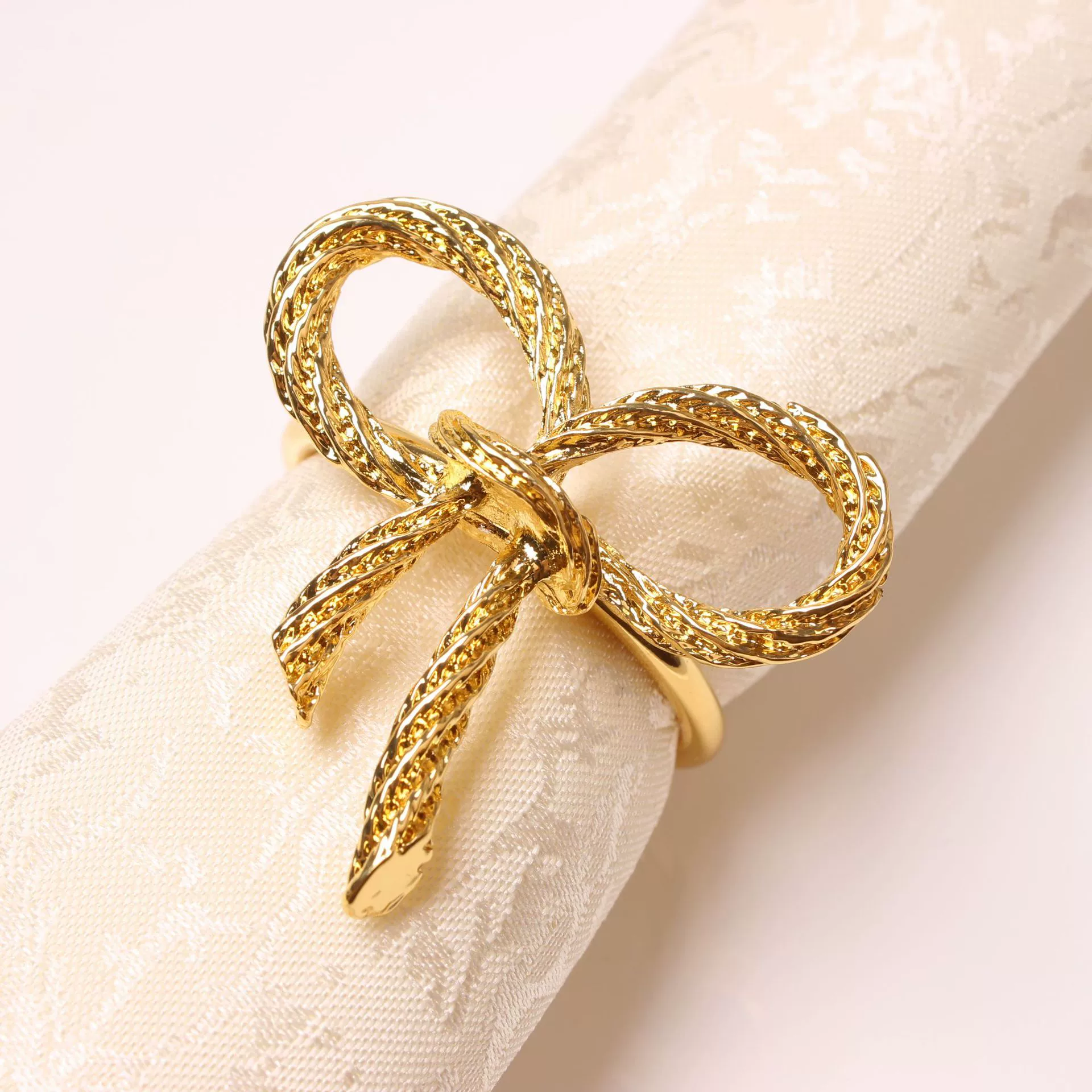 Golden paper napkins with bow, bow tie, fashionable accessory, simple and elegant design