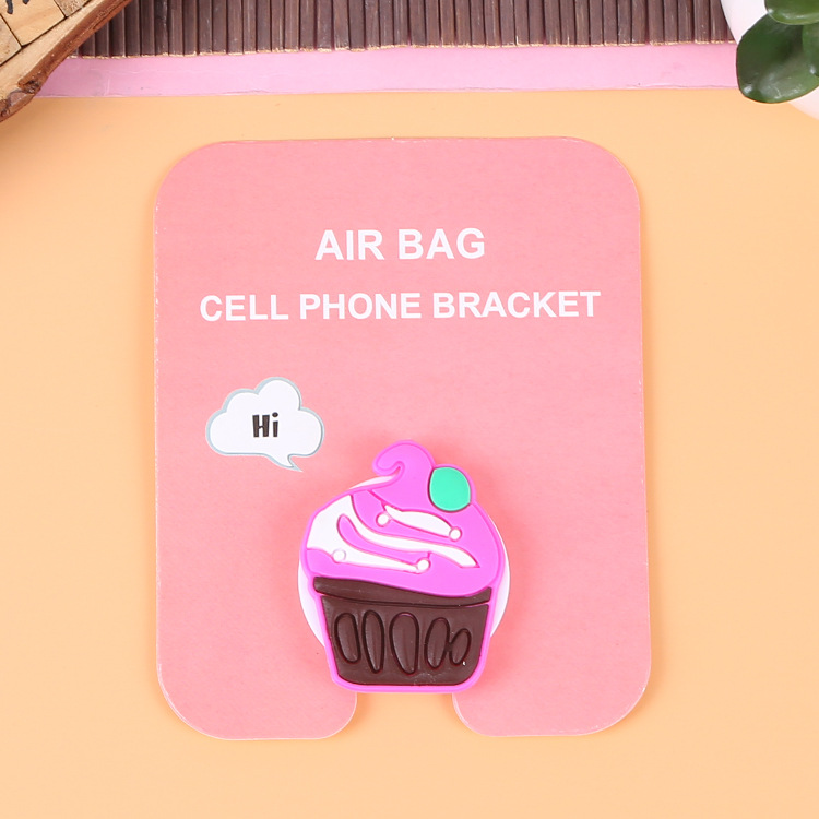 En stock al por mayor TikTok Cartoon creativo soporte de teléfono móvil puede soportar airbag soporte de teléfono móvil soporte de escritorio