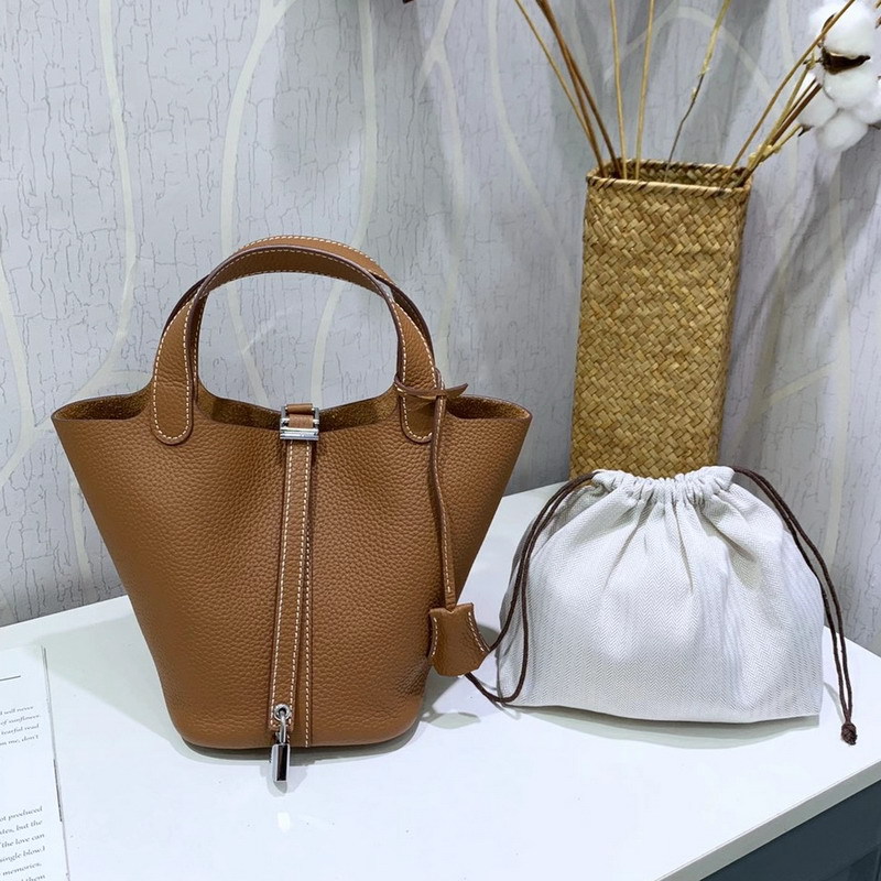 El nuevo bolso de cesta de verduras de marea de cuero togo de piel de vaca de capa superior 2025, bolso de cubo con cerradura de mano, bolso de cuero para mujer