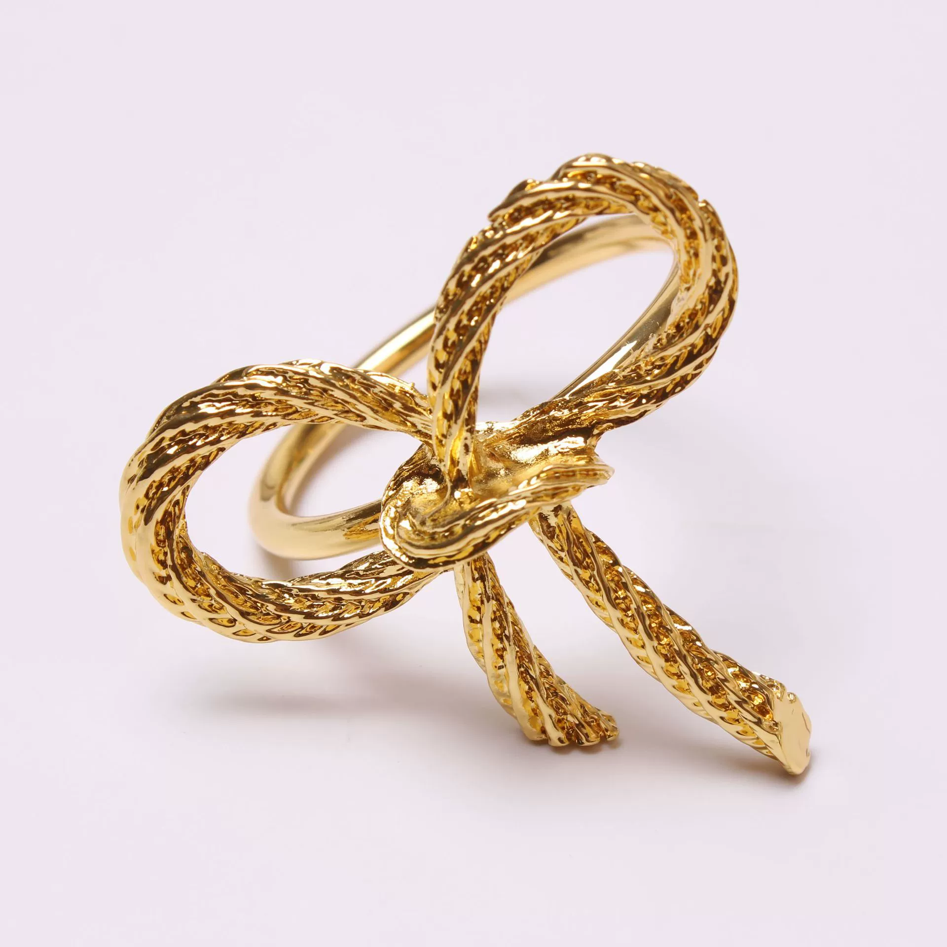 Golden paper napkins with bow, bow tie, fashionable accessory, simple and elegant design