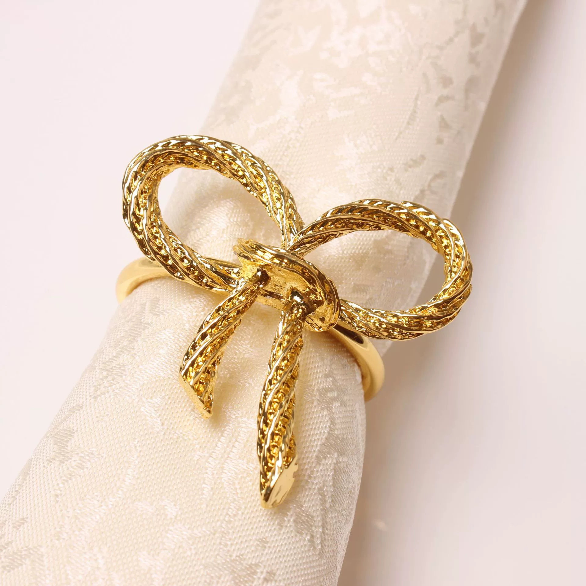Golden paper napkins with bow, bow tie, fashionable accessory, simple and elegant design