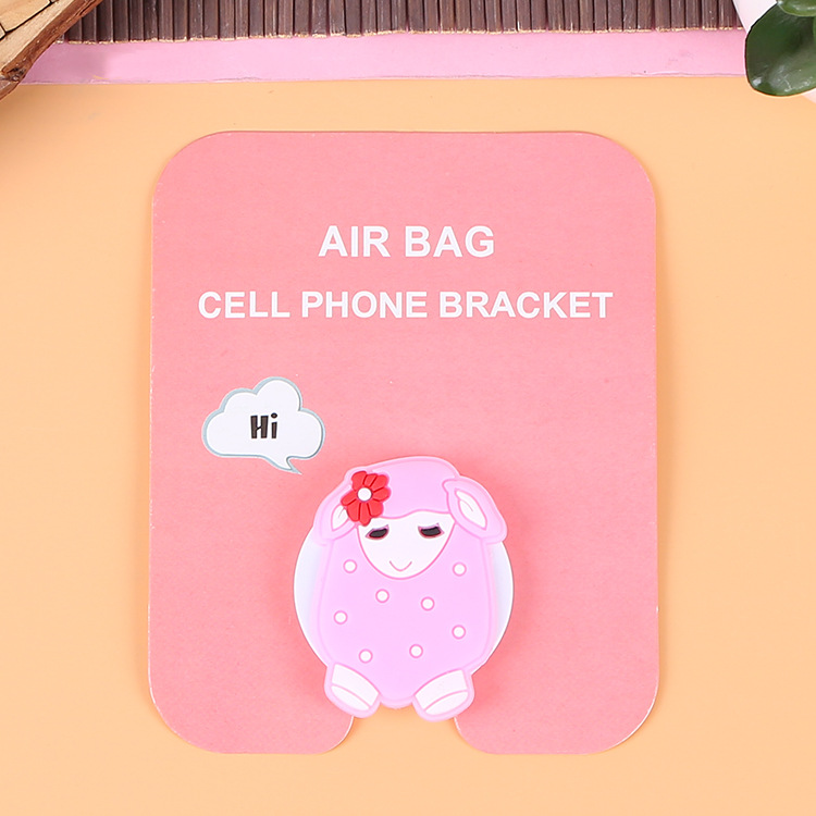 En stock al por mayor TikTok Cartoon creativo soporte de teléfono móvil puede soportar airbag soporte de teléfono móvil soporte de escritorio