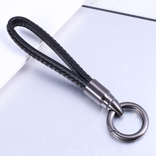 Creative bullet-shaped rotating keychain for men and women, genuine leather car keychain, alloy pendant, advertising gift item.