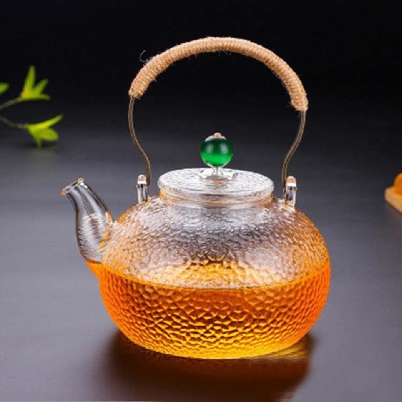 Fábrica al por mayor tetera de vidrio borosilicato hogar juego de té flor tetera de cobre martillado tetera fabricante de té