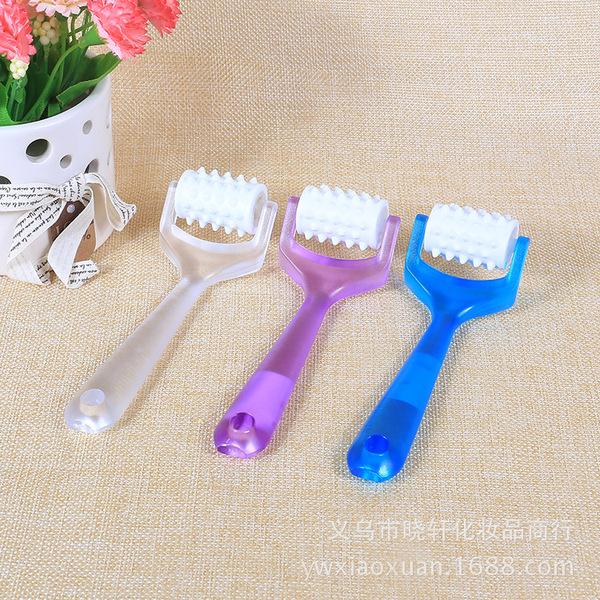 small multicoloured plastic cosmetic massager for face