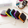 Handheld headphones, organizer bag, purse, mobile phone, charger, small coins, wallet, storage box