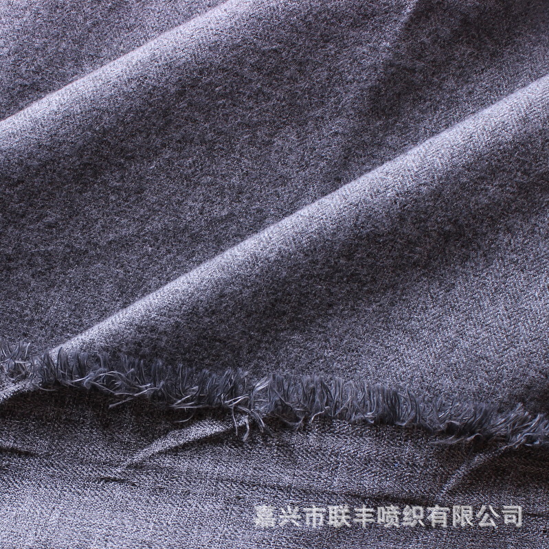 现货供应黑白丝色织人字斜纹空变拉毛布 高档夹克羽绒服服装面料