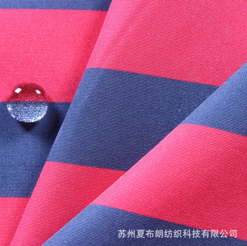 厂家热卖全涤平纹桃皮绒横条印花防水PA涂层化妆包手袋购物袋面料