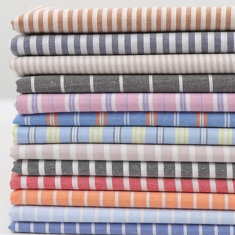 5涤棉平纹牛津纺条子布 简约衬衫男女装箱包里布面料 现货批发