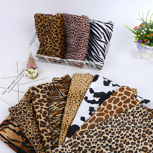 Factory wholesale short-pile plush fabric with animal prints: cow, tiger, leopard, and zebra patterns—perfect for sofa cushions and toy materials.