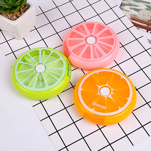 Factory direct sale round weekly medicine box with seven compartments, rotating for seven days, portable mini plastic medicine box for personal use.