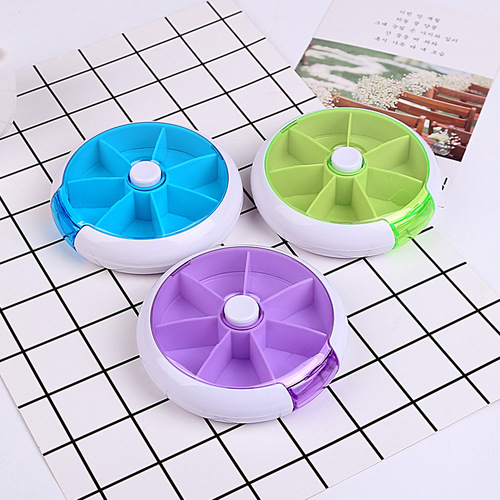 Factory direct sale round weekly medicine box with seven compartments, rotating for seven days, portable mini plastic medicine box for personal use.