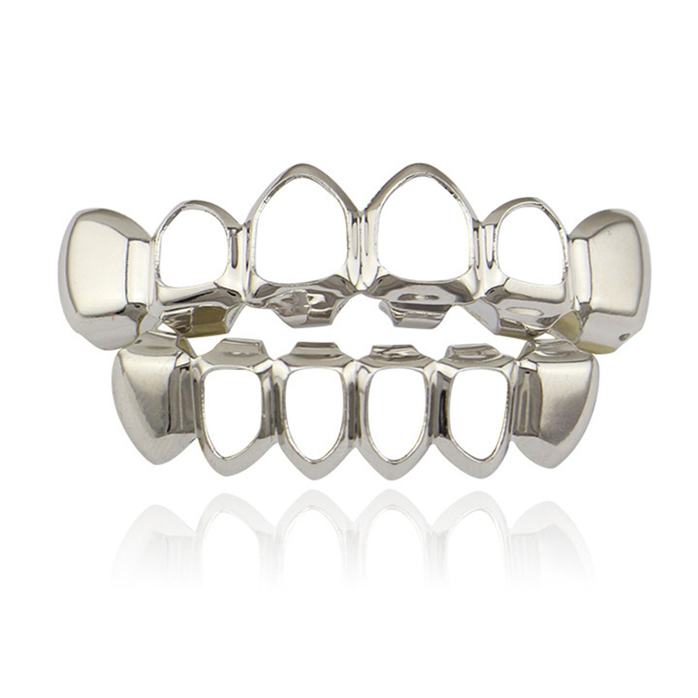 Europea y americana joyería brillante hueco colmillos hip hop tirantes para hombres y mujeres mismo Grillz18K electrochapado cobre oro dientes