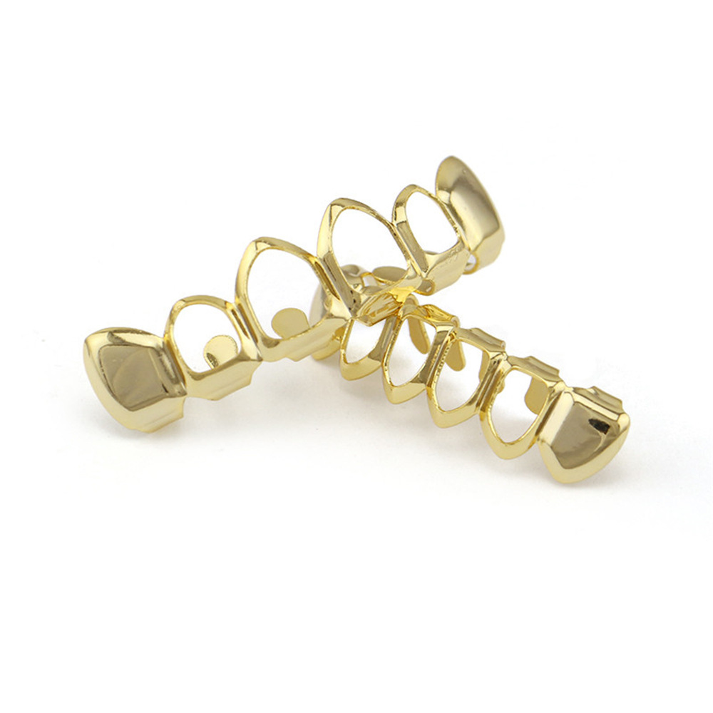 Europea y americana joyería brillante hueco colmillos hip hop tirantes para hombres y mujeres mismo Grillz18K electrochapado cobre oro dientes