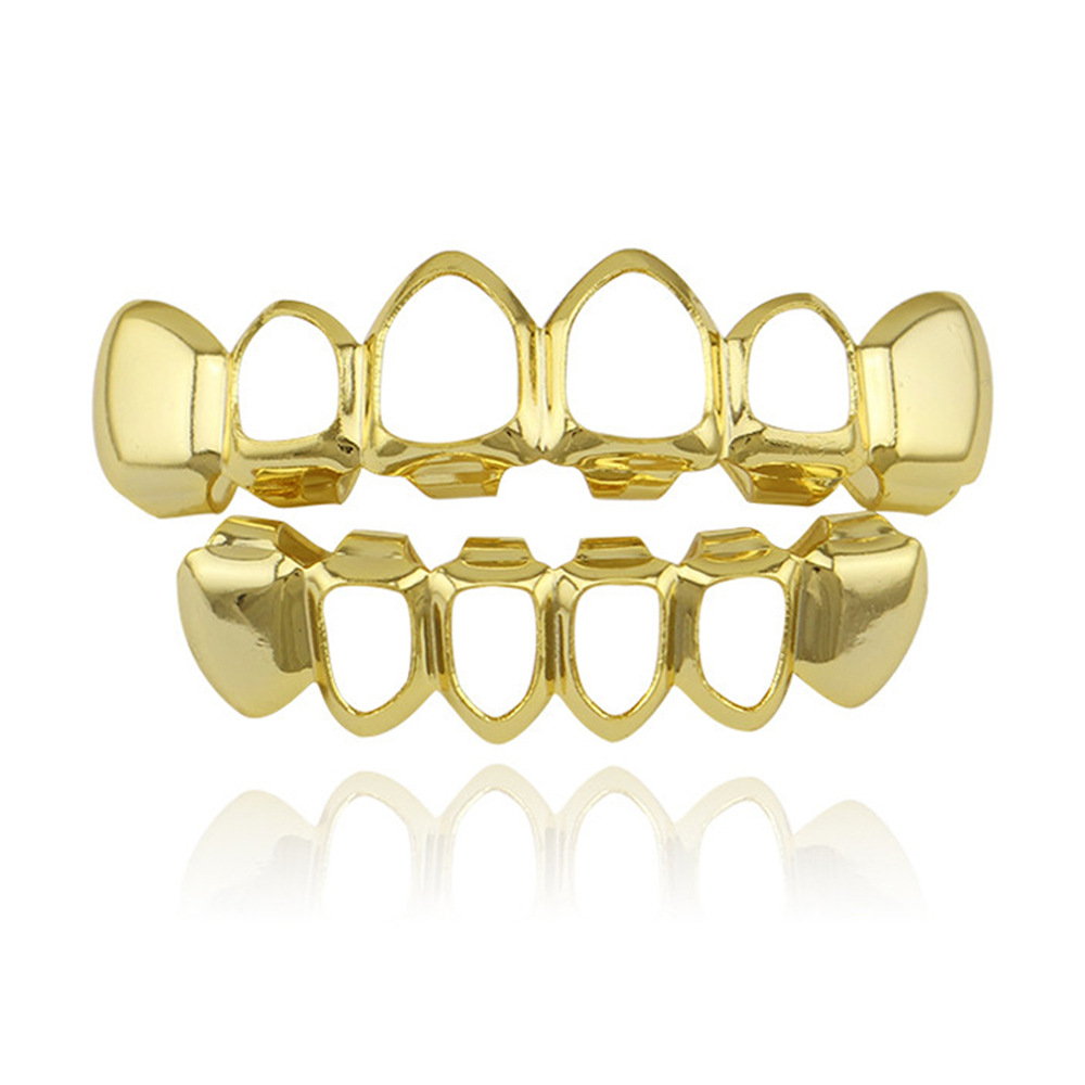 Europea y americana joyería brillante hueco colmillos hip hop tirantes para hombres y mujeres mismo Grillz18K electrochapado cobre oro dientes