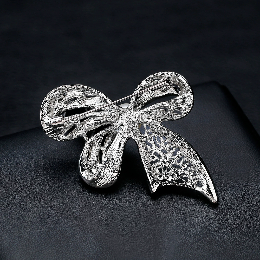 White brooch with bow lapel pin, bag accessory