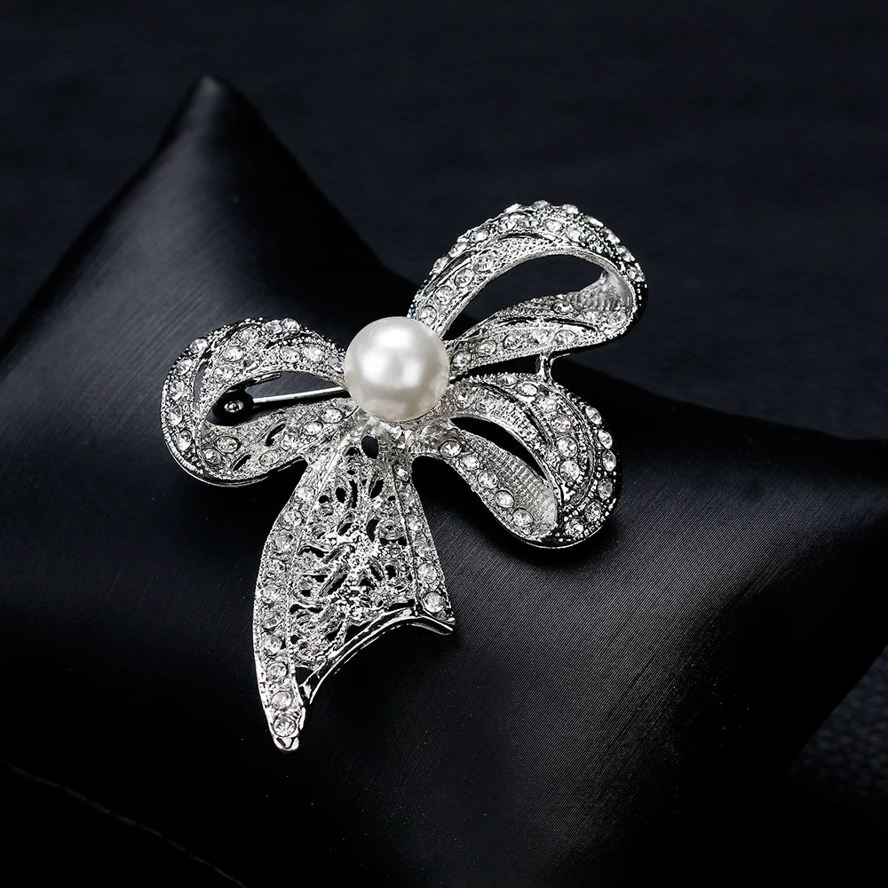 White brooch with bow lapel pin, bag accessory