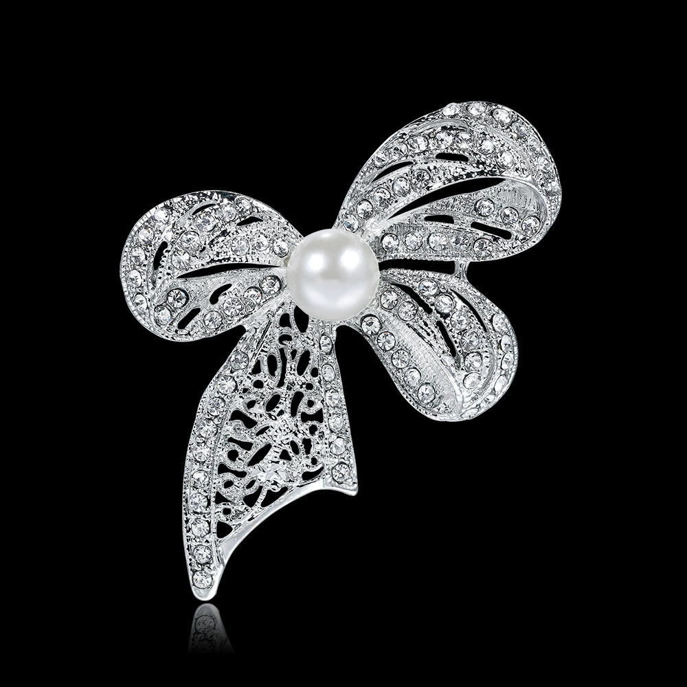 White brooch with bow lapel pin, bag accessory
