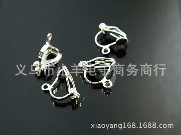 There is a triangle clip with a hanging hole and silver