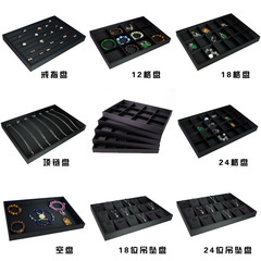 商品の皿を見ます。ジュエリーのアクセサリーの収納箱の指輪のネックレスは布の皿の黒い腕時計を引いて皿を展示します。