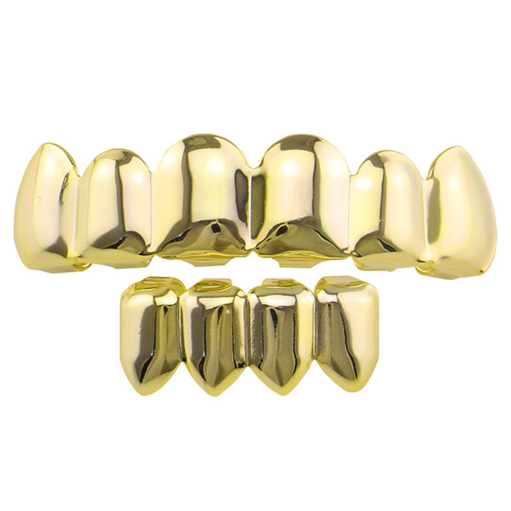 Europea y americana joyería brillante hueco colmillos hip hop tirantes para hombres y mujeres mismo Grillz18K electrochapado cobre oro dientes