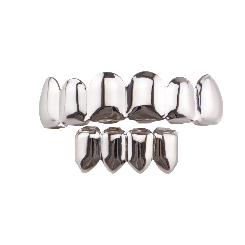 Europea y americana joyería brillante hueco colmillos hip hop tirantes para hombres y mujeres mismo Grillz18K electrochapado cobre oro dientes