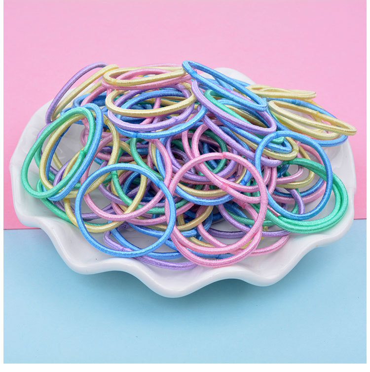 Venta caliente en línea cuerda de pelo 100 piezas banda de pelo para niños bebé color caramelo cuerda de pelo niña banda de goma accesorios para el cabello al por mayor