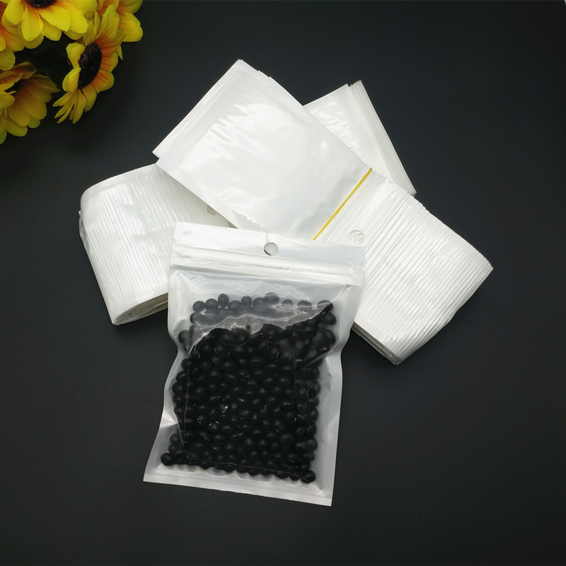 Fábrica al por mayor de película de perlas Yin y Yang bolsa de hueso blanco de bolsillo sellado bolsa de accesorios electrónicos translúcido bolsa de embalaje autosellante