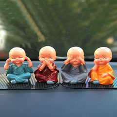 Four pieces set of Zen-themed creative car accessories featuring little monks in a car, ensuring peace and tranquility for your vehicle interior.