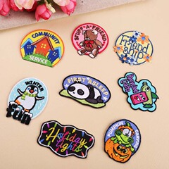 Embroidered fabric patches, computer-embroidered badges, handmade burn-edge designs, card-style cartoon toy house badges, and apparel patches