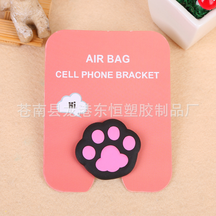 En stock al por mayor TikTok Cartoon creativo soporte de teléfono móvil puede soportar airbag soporte de teléfono móvil soporte de escritorio