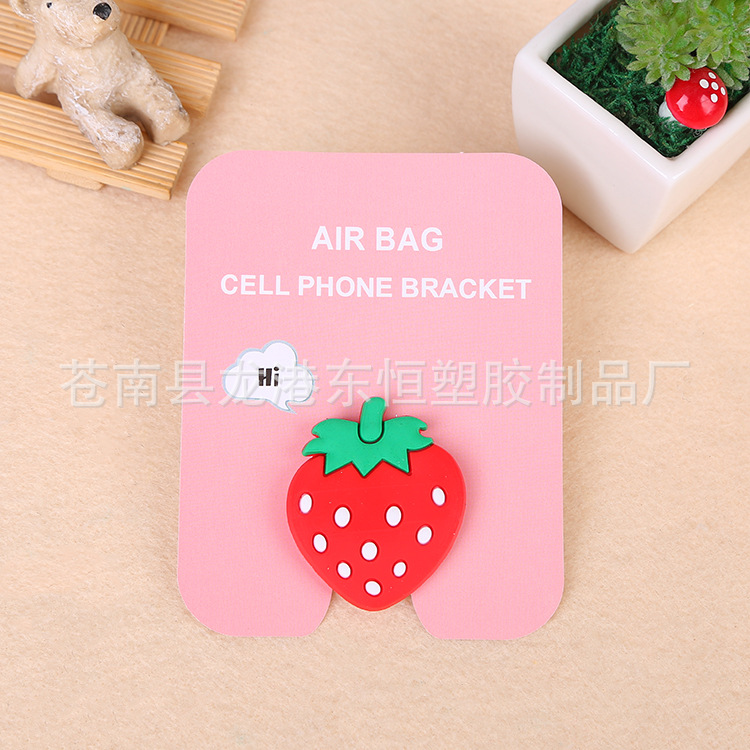 En stock al por mayor TikTok Cartoon creativo soporte de teléfono móvil puede soportar airbag soporte de teléfono móvil soporte de escritorio