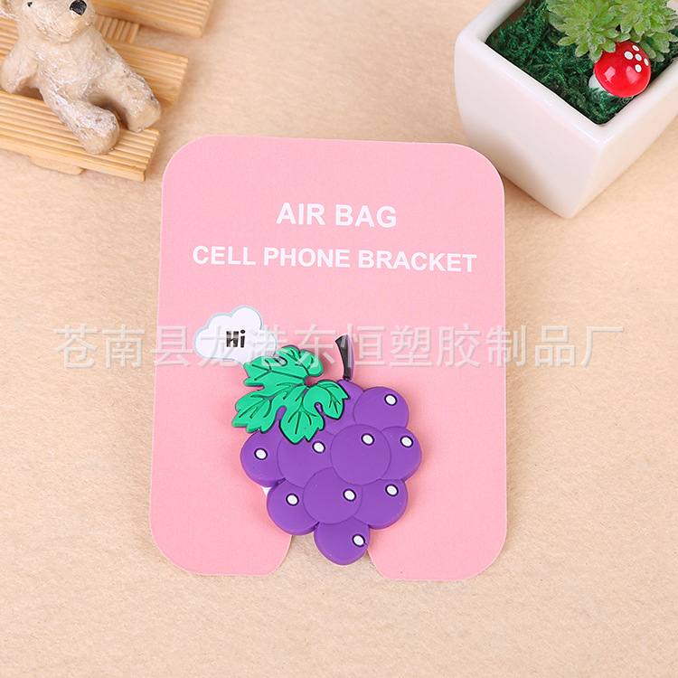 En stock al por mayor TikTok Cartoon creativo soporte de teléfono móvil puede soportar airbag soporte de teléfono móvil soporte de escritorio